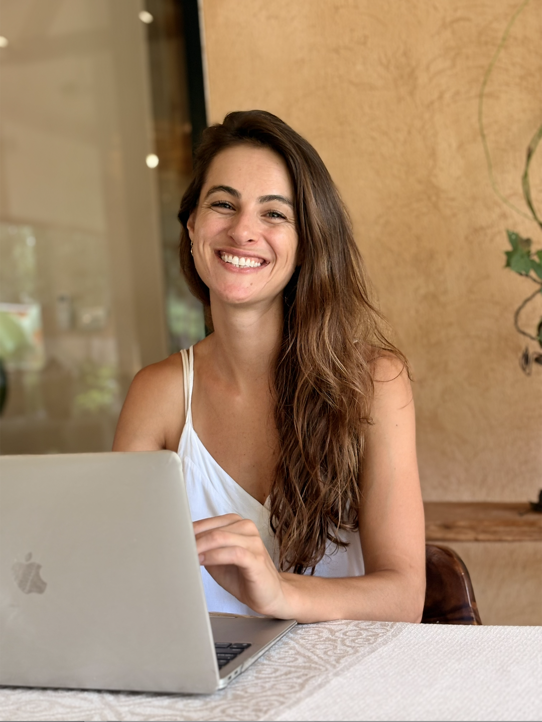 Danielle Ronit smiling with her laptop